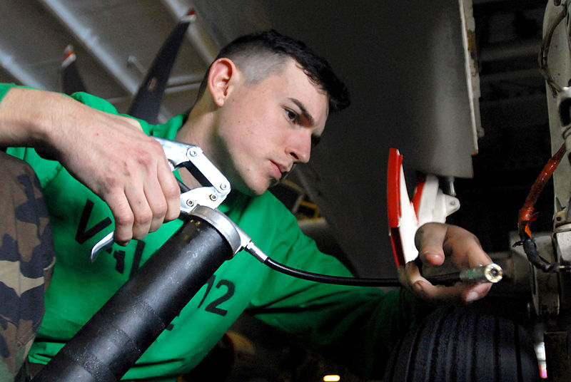 Sailor Using a Grease Gun